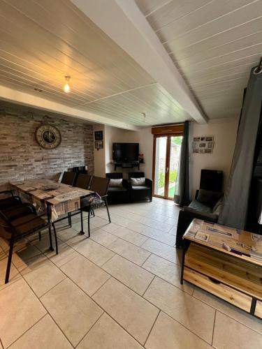 a living room with a couch and a table at Les marins des LYS, Cayeux sur mer, Baie de somme in Cayeux-sur-Mer