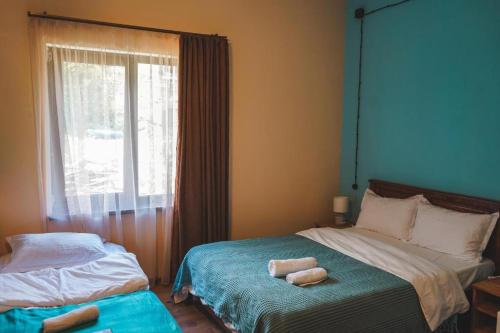 a bedroom with a bed with two towels on it at Fiten house in Stepantsminda
