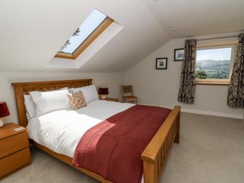 a bedroom with a large bed and a window at Little Penrhosgoch Barn in Llandrindod Wells
