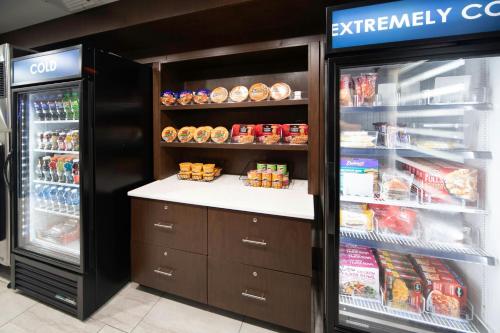 a grocery store with an open refrigerator with food at Four Points by Sheraton Fayetteville Fort Bragg in Fayetteville