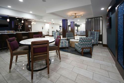 a waiting room with a table and chairs at Four Points by Sheraton Fayetteville Fort Bragg in Fayetteville