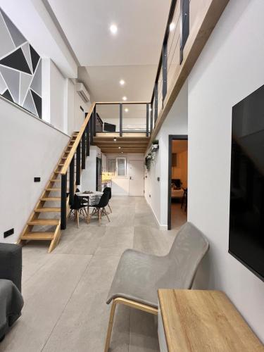 an open living room with a staircase and a dining room at Apartamento Castillejos 4 in Tarifa