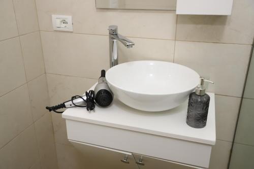 a white sink sitting on a counter in a bathroom at Vila Vreko in Berat