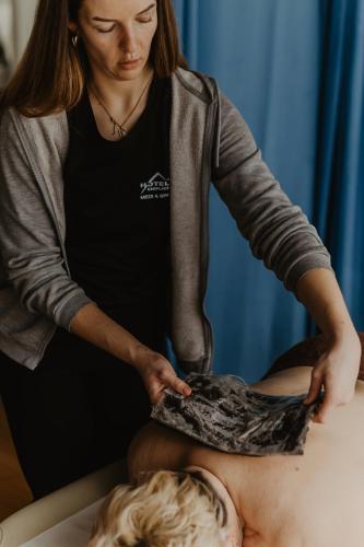 a woman giving a man a massage at Hotel Cieplice MEDI & SPA in Jelenia Góra