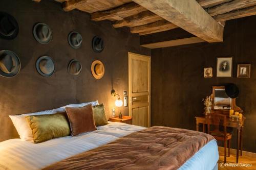 a bedroom with a bed and a wall with plates on it at Country Villa With Indoor Pool In Beaujolais in Romanèche-Thorins