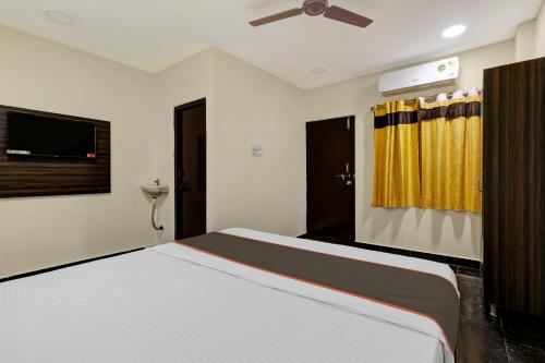 a bedroom with a bed and a ceiling fan at Hotel O AYWA STAYINN in Dhundgol