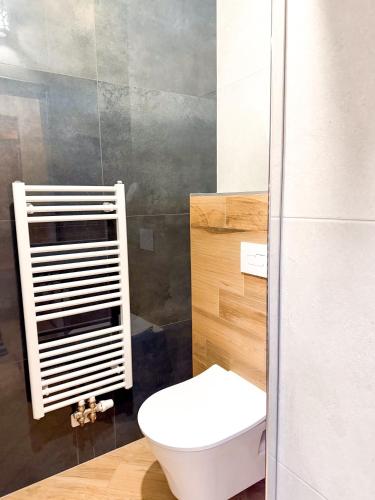 a bathroom with a white toilet and a sink at Školní 60 in Pelhřimov