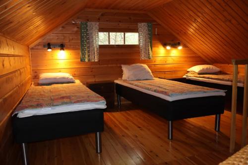 Postel nebo postele na pokoji v ubytování Ounasloma Holiday Cottages