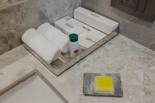 a bathroom with a box of towels and a sponge at The Tivoli New Delhi in New Delhi