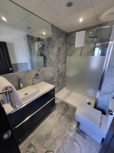 a bathroom with a sink and a tub and a toilet at 272-274 Accommodation AT in Blackpool