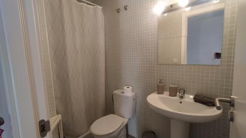 a bathroom with a white toilet and a sink at Casa Rincón Medanero in El Médano