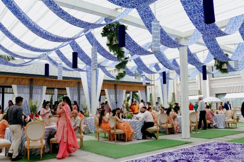 a wedding reception in a pavilion with blue and white ribbons at The Tivoli New Delhi in New Delhi