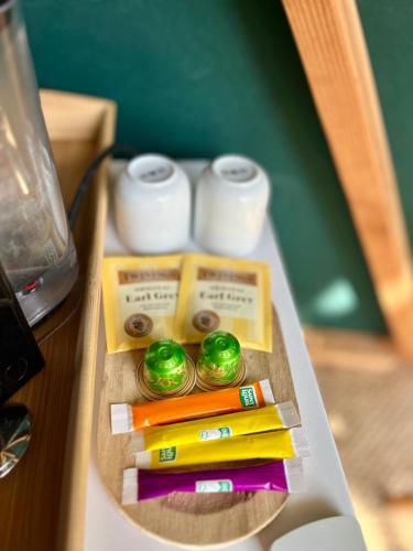 a table with colored pencils and batteries on it at Le dôme en seine, proche Giverny in Moisson