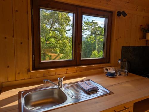 a kitchen counter with a sink and a window at Tiny House - Natur und Komfort in Kulmbach