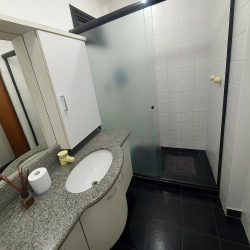 a bathroom with a toilet and a sink and a shower at Residence Scala in Fortaleza