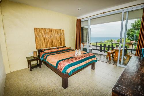 a bedroom with a bed with a view of the ocean at Sairee View Resort in Koh Tao