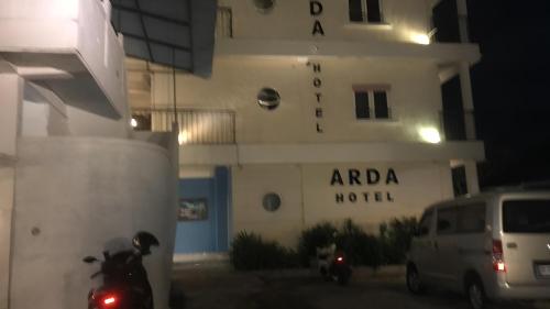 a motorcycle parked in front of a building at night at Hotel Arda Bali in Negara