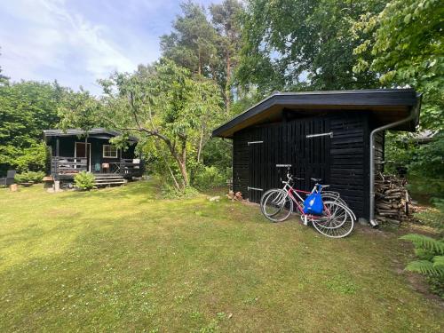 a bike parked in front of a shed at Wonderfull House By Liseleje Strand in Melby