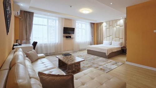 a living room with a couch and a bed at Copper hotel Erdenet city Mongolia in Erdenet