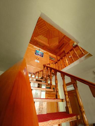 a view of a wooden staircase in a house at Saanjh by Limitless Stays in Bāgi