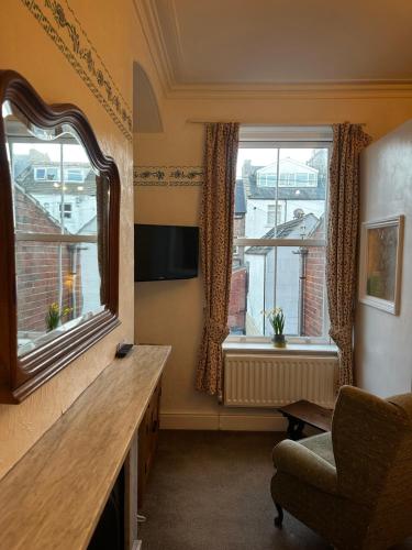 a living room with a large window and a chair at Bleak House in Whitby