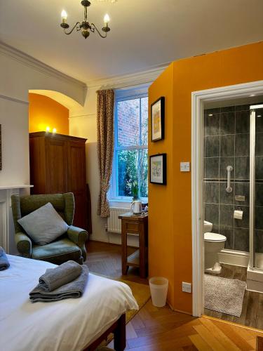 a bedroom with a bed and a bathroom with a shower at Bleak House in Whitby