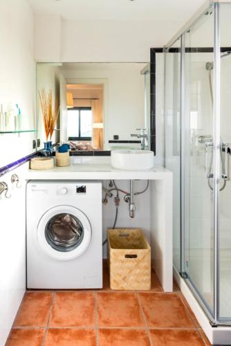 a bathroom with a washing machine and a shower at Begur Sunset 2 bedroom loft close to the center of Begur. With terrace and gorgeous sea views H42 in Begur