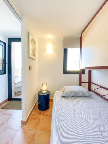 a bedroom with a bed and a lamp on a table at Begur Sunset 2 bedroom loft close to the center of Begur. With terrace and gorgeous sea views H42 in Begur