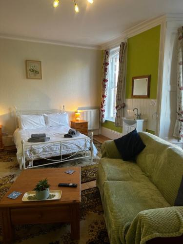 a living room with a bed and a couch at Bleak House in Whitby