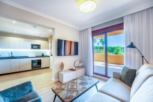 a living room with a couch and a table at Royal Marbella Golf Resort in Estepona