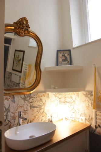 a bathroom with a sink and a mirror on a counter at Il Gelsomino in Capranica