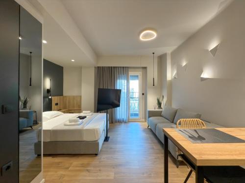 a living room with a bed and a couch at TWO ENTIRE APARTMENTS LIV Luxury Central C-D in Thessaloniki