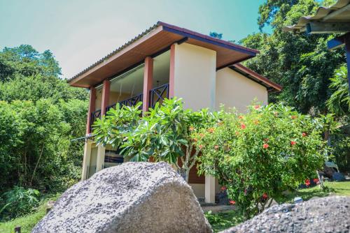 a house with a rock in front of it at Sairee View Resort in Koh Tao