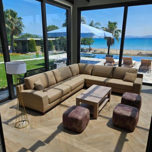 a living room with a couch and a table at Evia Palm Beach Villa in Politiká