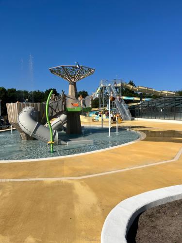 a water park with a water slide at Camping 4 étoiles Mobile home 4 à 6 personnes in Aureilhan