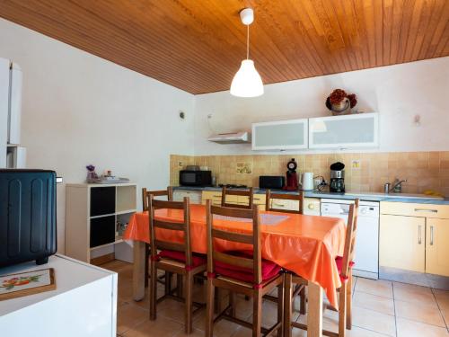 a kitchen with a table and chairs in a room at Gites Air Marin in Lannion