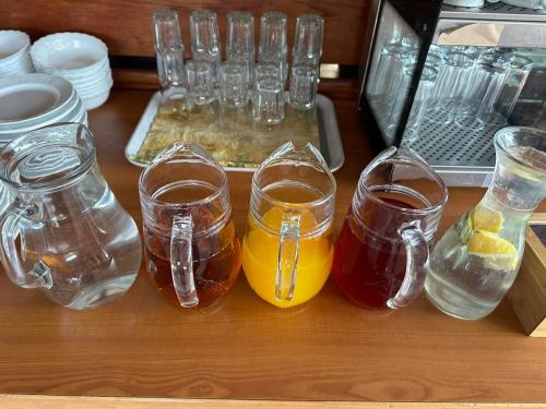 a wooden table with glasses of drinks on a table at Hotel Paradiesquelle in Puchberg am Schneeberg