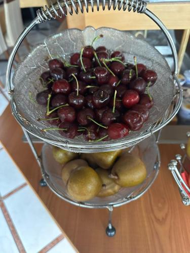 a bowl of fruit on a plate on a table at Hotel Paradiesquelle in Puchberg am Schneeberg