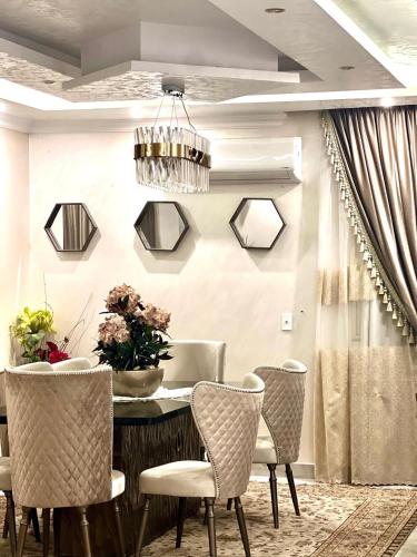 a dining room with a table and chairs at Luxurious apartment in New cairo