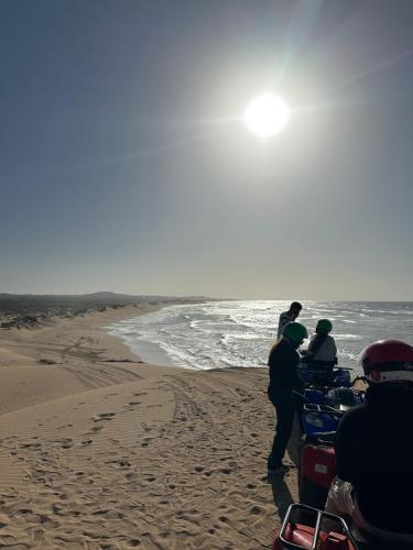 a group of people standing on the beach at Villa Sakina Essaouira in Ounagha