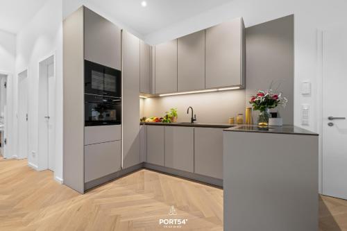 a kitchen with white cabinets and a sink at Apartments Hotel Stadt Hamburg in Westerland (Sylt)