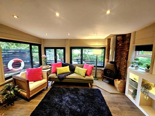 a living room with two couches and a fireplace at River View in Tonbridge