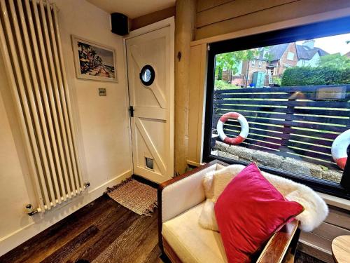 a living room with a couch and a large window at River View in Tonbridge