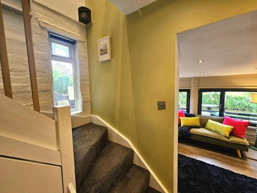 a room with stairs and a couch and a window at River View in Tonbridge