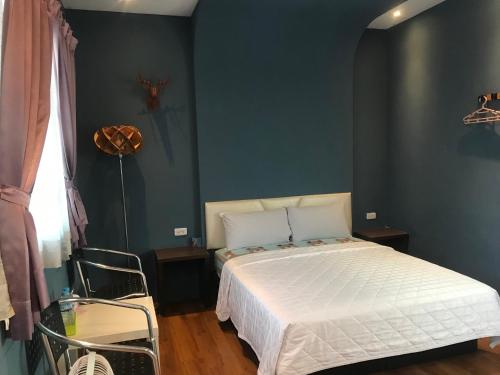 Postel nebo postele na pokoji v ubytování 墾丁貝殼灣旅店