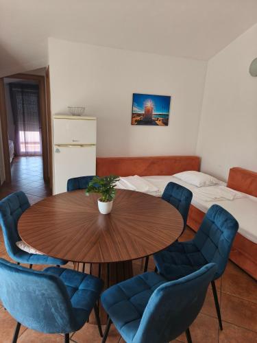 a room with a table and chairs and a bed at Perla Apartments in Poreč