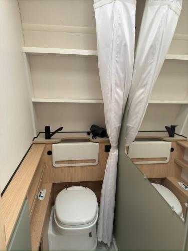 a small bathroom with a toilet in a room at On Wheels by Yerra in Yervandashat