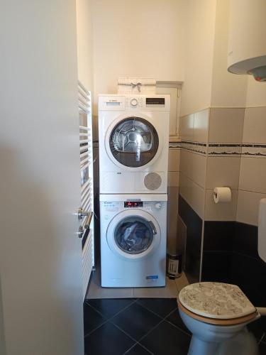 a washer and dryer in a small bathroom at New,Modern apartment near Split andTrogir in Kaštela
