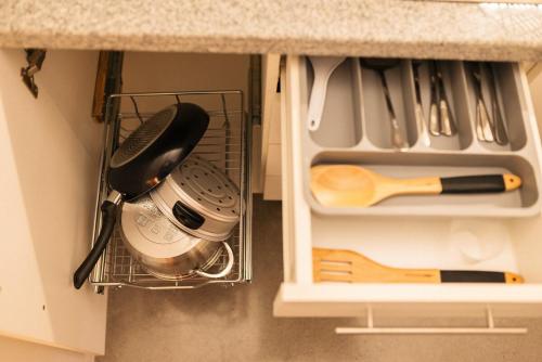 a cupboard with a kitchen utensils and a whisk at The Cube in Cubao in Quezon City