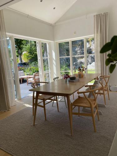 a dining room with a wooden table and chairs at Villa Lysholmen in Särö